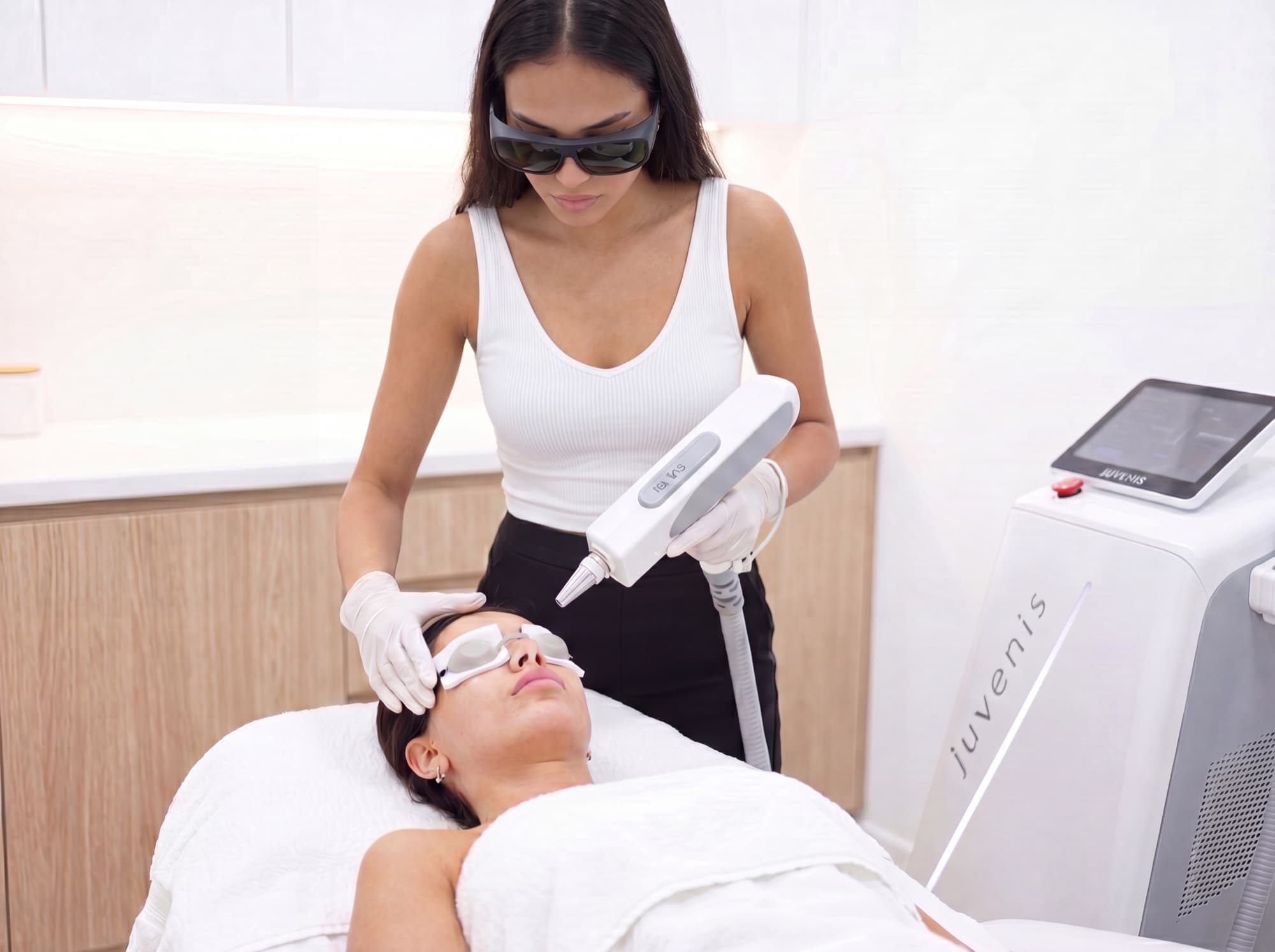 Practitioner treating a patient with a Juvenis device